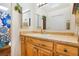 A bathroom featuring a wood vanity with a large mirror and floral decoration at 1152 S Yosemite Way # 29, Denver, CO 80247