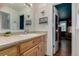 Bathroom featuring a vanity and open doorway to bedroom at 1152 S Yosemite Way # 29, Denver, CO 80247