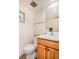 Bright, clean half-bathroom with a wooden vanity, a toilet and neutral decor at 1152 S Yosemite Way # 29, Denver, CO 80247