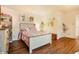 Well-lit bedroom showcasing wood floors, unique art, and a cozy atmosphere at 1152 S Yosemite Way # 29, Denver, CO 80247