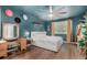 A primary bedroom displays wood-look floors, blue walls and ceiling, and bright windows at 1152 S Yosemite Way # 29, Denver, CO 80247