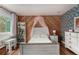 This bedroom features a wood accent wall, vibrant wallpaper, a canopy bed, and natural light from the window at 1152 S Yosemite Way # 29, Denver, CO 80247