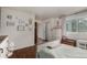 View of a charming bedroom featuring hardwood floors, a large window, and stylish decor and furniture at 1152 S Yosemite Way # 29, Denver, CO 80247