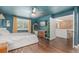 Bedroom featuring wood-look floors, blue walls and ceiling, and a view into another room at 1152 S Yosemite Way # 29, Denver, CO 80247