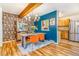 Dining room showcasing a wooden table, vibrant orange chairs, and statement wallpaper at 1152 S Yosemite Way # 29, Denver, CO 80247