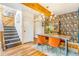 Stylish dining room features hardwood floors, a modern chandelier, and eye-catching wallpaper at 1152 S Yosemite Way # 29, Denver, CO 80247