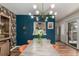 The dining room features a modern chandelier, bold accent wall, and a view into the kitchen for easy serving at 1152 S Yosemite Way # 29, Denver, CO 80247