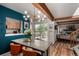 The dining area features a large table, a modern chandelier, and opens to a patio for easy outdoor entertaining at 1152 S Yosemite Way # 29, Denver, CO 80247