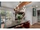 The dining room features a large table, a modern chandelier, and is open to the living room and patio at 1152 S Yosemite Way # 29, Denver, CO 80247