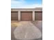 Row of garages with brown doors, offering convenient and secure parking for residents and their vehicles at 1152 S Yosemite Way # 29, Denver, CO 80247
