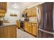 Kitchen with wooden cabinets, granite counters, stainless steel appliances and tile flooring at 1152 S Yosemite Way # 29, Denver, CO 80247