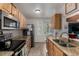 Well-lit kitchen features stainless steel appliances, granite countertops and light wood cabinetry at 1152 S Yosemite Way # 29, Denver, CO 80247