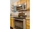 Close up of oven with oak cabinets and granite counters, offering modern features and style at 1152 S Yosemite Way # 29, Denver, CO 80247