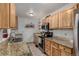 The kitchen features granite countertops and stainless steel appliances, including microwave and stove at 1152 S Yosemite Way # 29, Denver, CO 80247