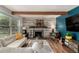 The living room offers a cozy fireplace, wood beam, and a comfortable seating area to enjoy at 1152 S Yosemite Way # 29, Denver, CO 80247
