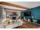 Inviting living room featuring a cozy fireplace, sleek TV, wood beams, and stylish décor for a modern feel at 1152 S Yosemite Way # 29, Denver, CO 80247