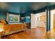 A main bedroom featuring a modern dresser and a door leading to a bathroom area at 1152 S Yosemite Way # 29, Denver, CO 80247
