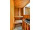 Relaxing at-home sauna with wood paneling, built-in bench, and heater with stones at 1152 S Yosemite Way # 29, Denver, CO 80247