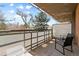 Balcony features chairs with view of mature trees and landscaping at 2500 S York St # 310, Denver, CO 80210