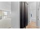 Bright hallway with natural light from the patio door and open view to the bathroom at 2500 S York St # 310, Denver, CO 80210
