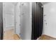 Hallway view with access to bathroom featuring a shower and tub combo with tiled walls at 2500 S York St # 310, Denver, CO 80210