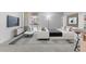 Bright living room with a balcony access, sleek furniture, and minimalist decor enhance the open and airy feel of the space at 2500 S York St # 310, Denver, CO 80210