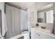 Cozy bathroom featuring a shower with patterned curtain, vanity and mirror at 4745 S Sherman St, Englewood, CO 80113