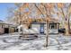 Charming remodeled home with a light blue door and snow-covered yard at 4745 S Sherman St, Englewood, CO 80113