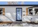 Renovated front entrance with light blue door and updated siding at 4745 S Sherman St, Englewood, CO 80113