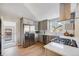 Updated kitchen with stainless steel appliances and a seamless flow into the adjacent living area at 4745 S Sherman St, Englewood, CO 80113