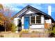 Charming craftsman home with a blue door and well-manicured landscaping at 4860 Stuart St, Denver, CO 80212