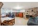 Basement space featuring a stone fireplace, wood paneling, and tile floors at 675 Holland St, Lakewood, CO 80215