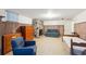 Basement area featuring a stone fireplace, wood paneling, and tile floors at 675 Holland St, Lakewood, CO 80215