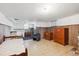 Basement space featuring cabinets, wood paneling, and tile floors at 675 Holland St, Lakewood, CO 80215