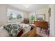 Comfortable bedroom bathed in natural light, showcasing hardwood floors and a dresser at 675 Holland St, Lakewood, CO 80215