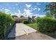 Charming home exterior with a well-manicured lawn and a long driveway at 675 Holland St, Lakewood, CO 80215