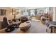 Living room featuring neutral carpet, a variety of decor, and comfortable seating at 675 Holland St, Lakewood, CO 80215