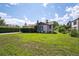 Spacious yard featuring lush lawn, mature trees, and classic architecture at 675 Holland St, Lakewood, CO 80215
