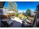 Relax on the expansive deck, complete with outdoor seating and umbrella, great for gatherings at 7083 Leopard Dr, Lone Tree, CO 80124