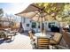 Large back deck with ample seating, table with umbrella, and grill, is ideal for entertaining guests at 7083 Leopard Dr, Lone Tree, CO 80124
