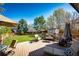 A spacious backyard featuring a well-maintained lawn, storage shed, and mature trees at 7083 Leopard Dr, Lone Tree, CO 80124