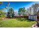 Lush green backyard with well-manicured lawn, mature trees, and storage shed at 7083 Leopard Dr, Lone Tree, CO 80124