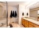 Bright bathroom features a double vanity, large mirror, and a separate shower and tub at 7083 Leopard Dr, Lone Tree, CO 80124