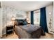 Cozy bedroom featuring stylish wallpaper, a comfortable bed, and ample natural light from the window at 7083 Leopard Dr, Lone Tree, CO 80124