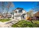 Two-story home with a well-manicured lawn, driveway, and partial tree shadow at 7083 Leopard Dr, Lone Tree, CO 80124