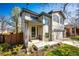 Inviting front entrance with a covered porch, stone accents, and a well-kept lawn at 7083 Leopard Dr, Lone Tree, CO 80124