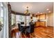 Eat-in kitchen featuring natural wood floors, a chandelier, and natural light at 7083 Leopard Dr, Lone Tree, CO 80124