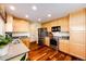 Bright kitchen featuring wooden cabinets, stainless steel appliances, and beautiful hardwood floors at 7083 Leopard Dr, Lone Tree, CO 80124