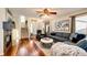 Open-concept living room with hardwood floors, a fireplace, and a comfortable seating area at 7083 Leopard Dr, Lone Tree, CO 80124