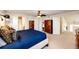 Large main bedroom with neutral carpet, ceiling fan, and two spacious closets at 7083 Leopard Dr, Lone Tree, CO 80124
